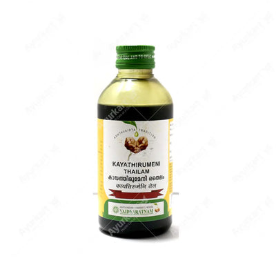 VAIDYARATNAM KAYATHIRUMENI THAILAM being applied to an ankle for pain relief.