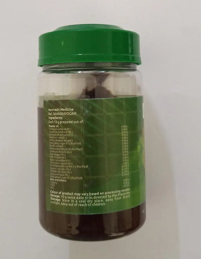 Pancha Jeeraka Gudam, a dark brown herbal jam on a spoon